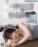 A woman laying on the floor in a magazine.