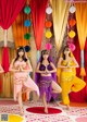 A group of young women dancing in front of a stage.