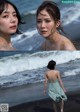 A woman in a blue dress walking on the beach.